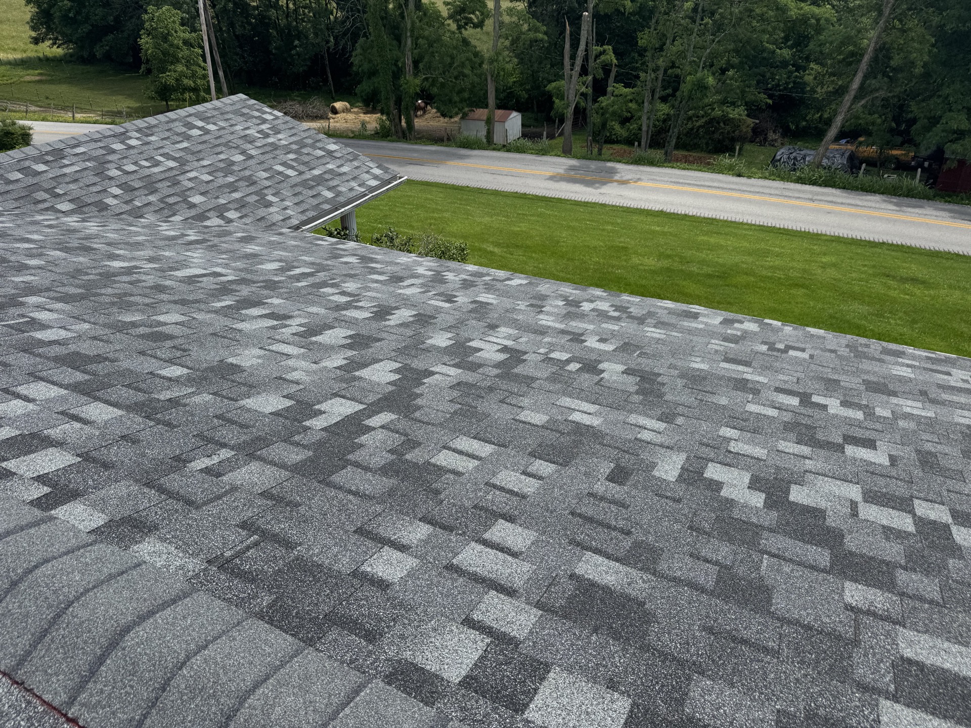 Close-up of newly installed gray architectural shingles on a residential roof.